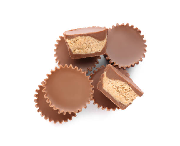 istock Cut and whole delicious peanut butter cups on white background, top view 1312795478
