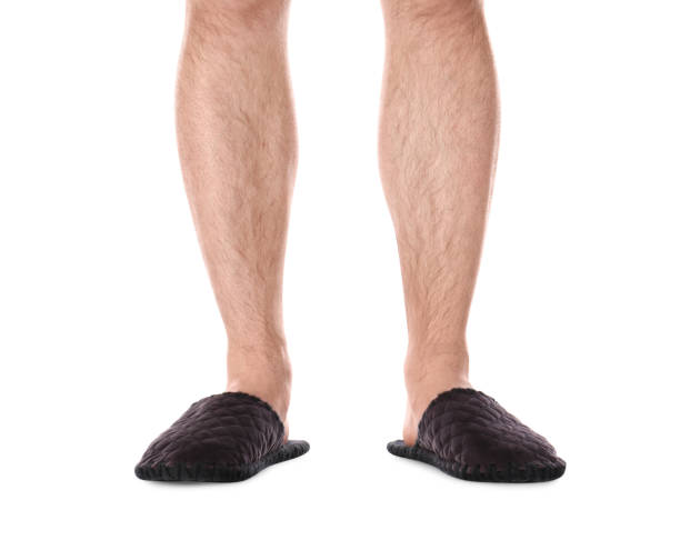 istock Man in warm soft slippers on white background, closeup 1312795515