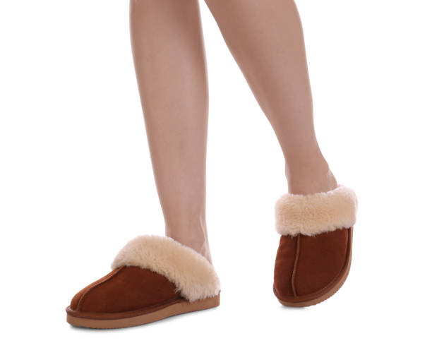 istock Woman in warm soft slippers on white background, closeup 1312795531