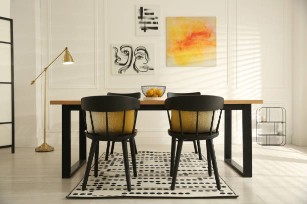 istock Stylish wooden dining table and chairs in room. Interior design 1312795559