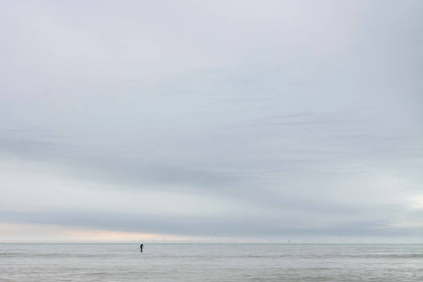 istock Paddle Boarder with Offshore Wind Turbines. 1312796853