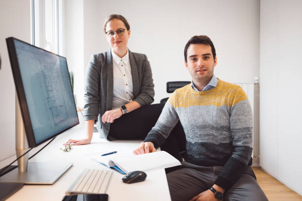 istock Portrait of two young architect in their home office 1312797989