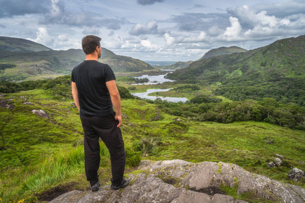 istock Middle age man standing on a rock and admiring beautiful Ladies View 1312798035