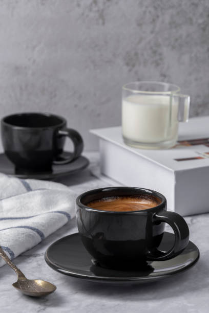 istock Hot espresso coffee with milk on marble table background. Coffee break at retro style coffee shop, fornt view for the menu 1312798119