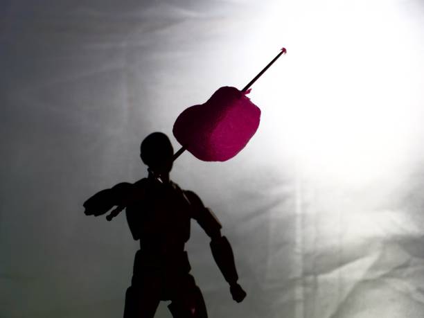 Skewered heart by shadowed figure