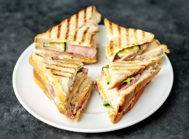 istock tasty sandwiches on a white plate on a stone background 1312799674