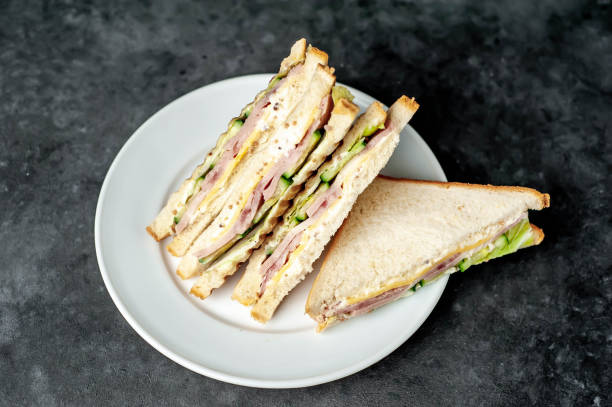 istock tasty sandwiches on a white plate on a stone background 1312799754