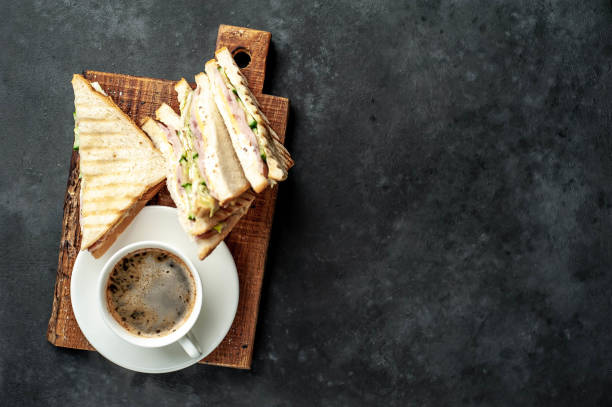 istock coffee and delicious sandwiches on a white plate on a stone background with copy space for your text 1312799854