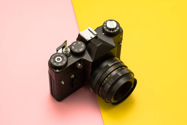 istock Retro photo camera on a two-tone background. 1312801444