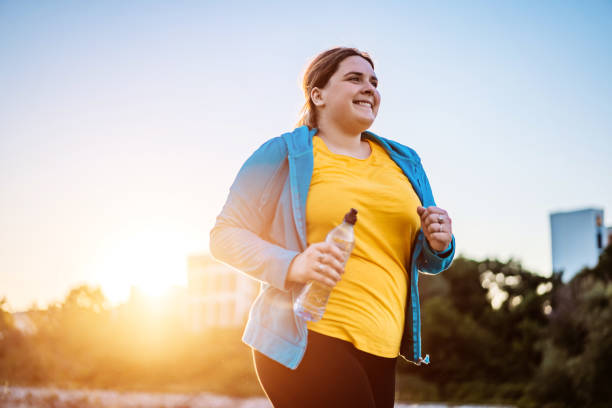 istock Young overweight woman running 1312803221