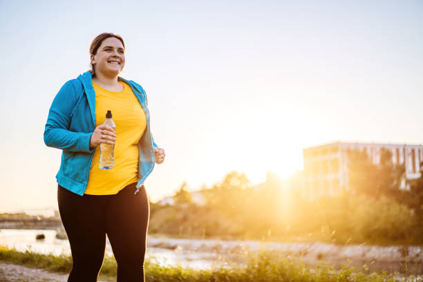 istock Young overweight woman running 1312804325