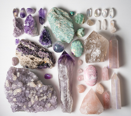 High angle shot of a table filled with different types of crystals inside during the day.