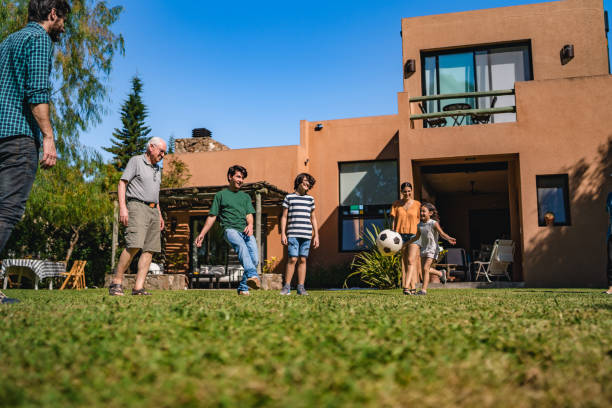 istock Family playing soccer on lawn 1312807715