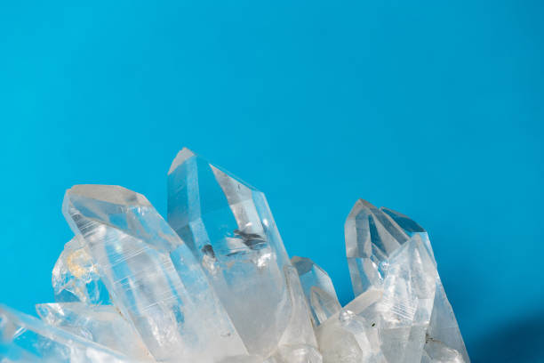 istock Clear Quartz Point Crystal Cluster on Blue Background 1312807853