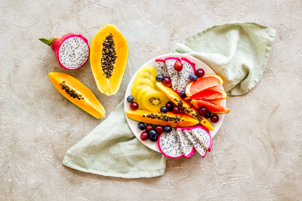 istock Exotic fruit dish with dragon fruit and papaya, top view 1312808917