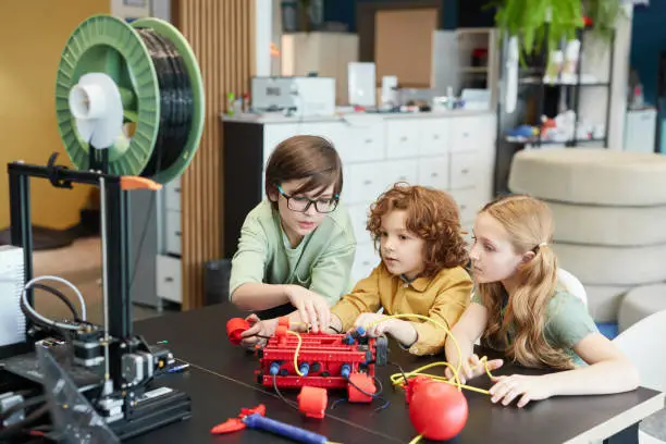 Photo of Kids Using 3D Printer at School