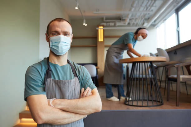 istock Waiter Wearing Mask in Cafe 1312810412