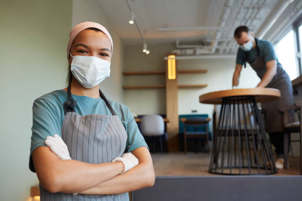 istock Waitress Wearing Mask in Cafe 1312810416
