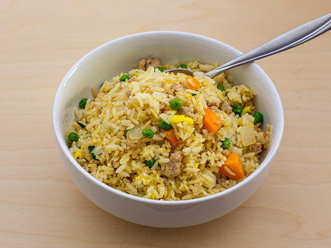 Homemade fried rice for quick and healthy eating during short lunch break or supplementary dish for main dinner course in Chinese or Thai styles.