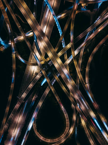 istock Aerial View of Complex Overpass and Busy Traffic at Night 1312812012