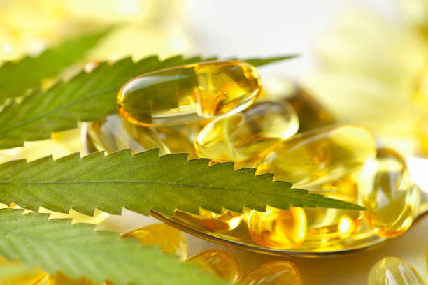 Medical cannabis products, leaf, capsules and CBD oil on white background. Pharmaceutical gelatin softgels with biological plant herbal. Organic dietary supplements concept stock photo