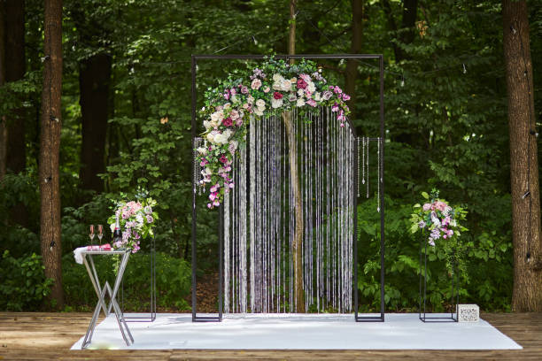 istock Beautiful wedding arch for ceremony in rustic style located in forest 1312814162