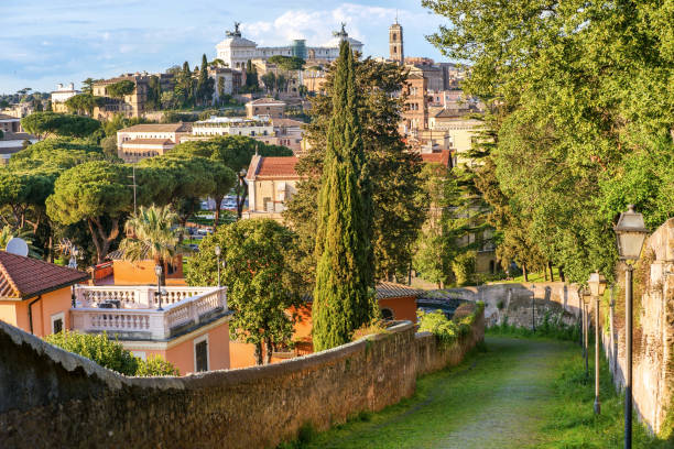 the ancient stone alley of monte savello on the aventine hill in rome with the campidoglio on the horizon - rome ancient rome skyline ancient imagens e fotografias de stock