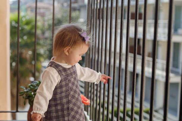 istock Girl on the balcony at home 1312819875