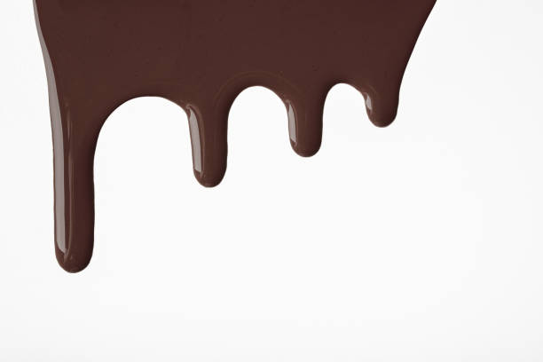 istock Dark chocolate liquid drops of paint flow down on isolated white background. Abstract brown color backdrop 1312823353