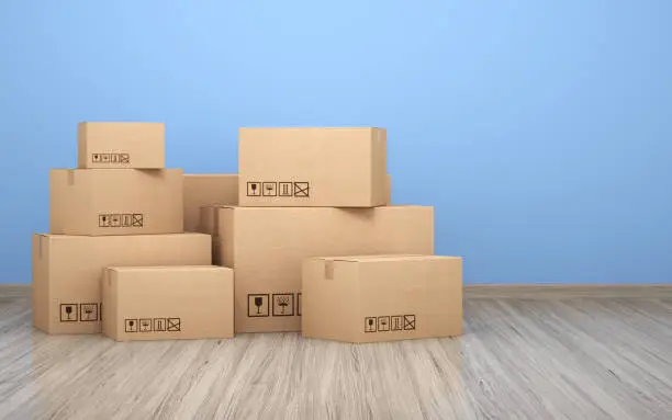 Photo of Cardboard boxs in front of the blue wall stock photo