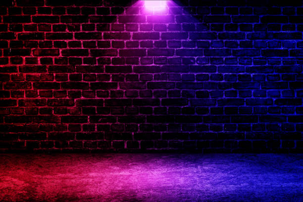 istock Studio dark room brick wall grunge texture background with red and blue lighting effect. 1312827281