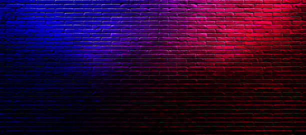 istock Studio dark room with lighting effect red and blue on brick wall grunge texture background for interior decoration. 1312827309
