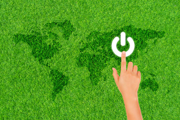istock Finger hand press on white electric power button icon on green grass for Earth Hour Event. 1312827885