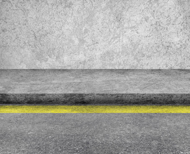 istock Concrete walkway or footpath beside asphalt street road. 1312827938