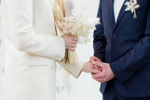 istock Bride and groom exchange wedding rings 1312829255
