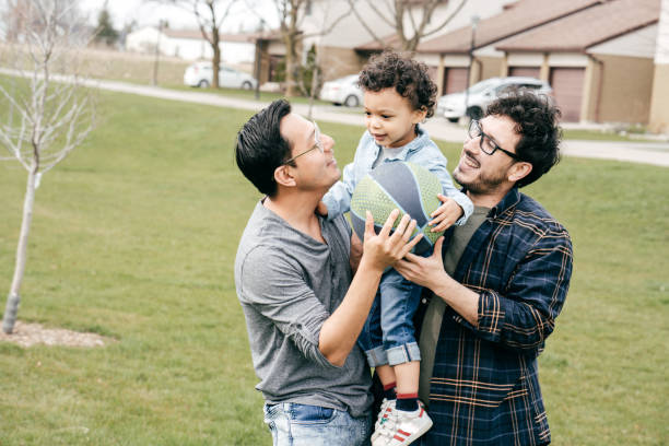 istock Happiness and parenting -two dads with son outdoor 1312829376