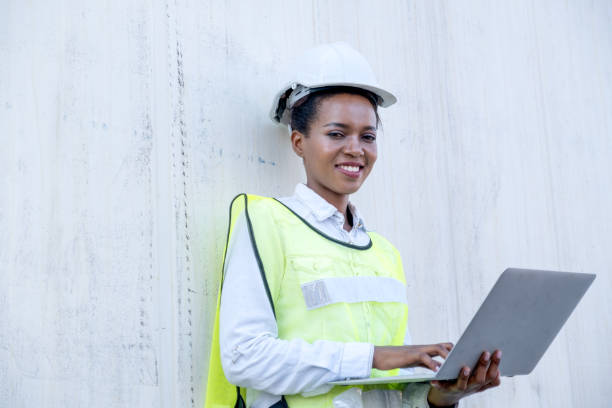 istock African American foreman woman hold laptop and lean on white cargo container also smile with look at camera in shipping area 1312830717