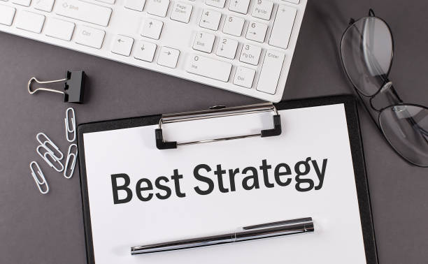 istock Office paper sheet with text BEST STRATEGY with office tols and keyboard. 1312831442