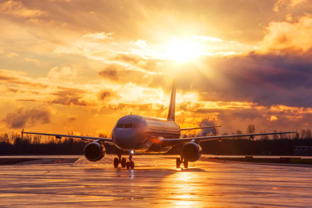 istock Airplane on airport runway under sunset view dramatic sky after the evening rain. 1312831802