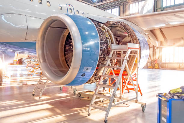 istock Opened aircraft engine in the hangar, illuminated by bright sunlight from outside the gate. 1312832324