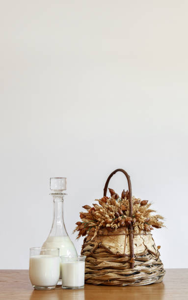istock Vertical white copyspace with milk bottle and glasses and flower basket 1312832366