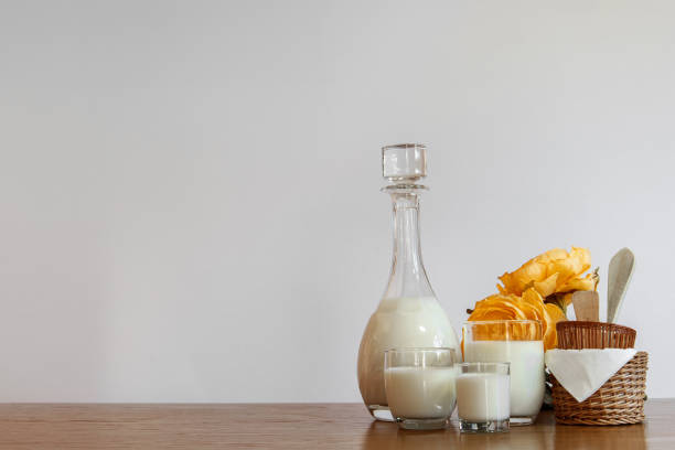 istock Horizontal white copyspace with milk bottle and glasses, yellow flowers and baskets 1312832490