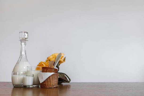 istock Horizontal white copyspace with milk bottle and glasses, yellow flowers and baskets 1312832522