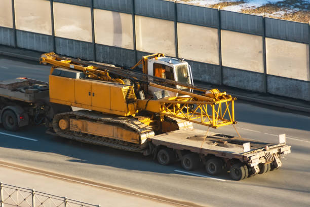 istock Transporting a folding jib crawler crane on a truck trailer. 1312832540