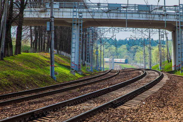 istock Railroad tracks and passenger train receding into the distance 1312834872