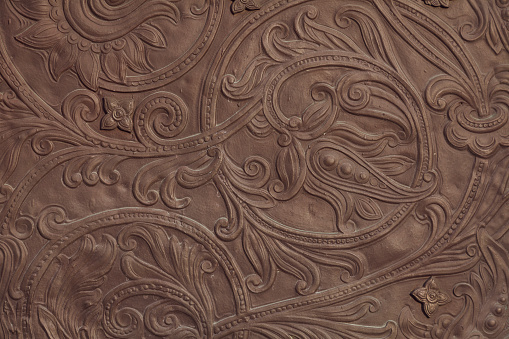 Embossed floral pattern on the gate of an ancient church
