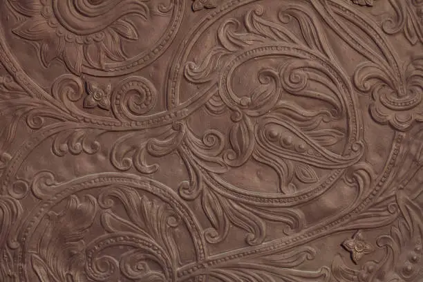 Photo of Embossed floral pattern on the gate of an ancient church