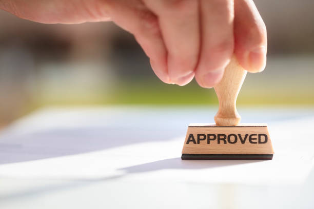 istock Businessman stamping approved stamp on document in meeting 1312835973