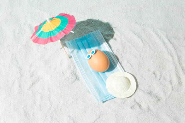 istock Summer Easter composition with eggs, virus mask, beach umbrella and glasses. Minimal pandemic or holiday concept. 1312837107