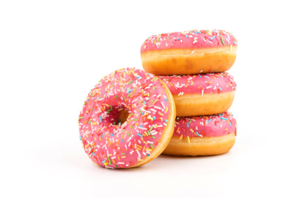 istock Fresh made Donuts isolated on white background. Doughnuts are traditional sweet pastries. Copy space for text. 1312838250